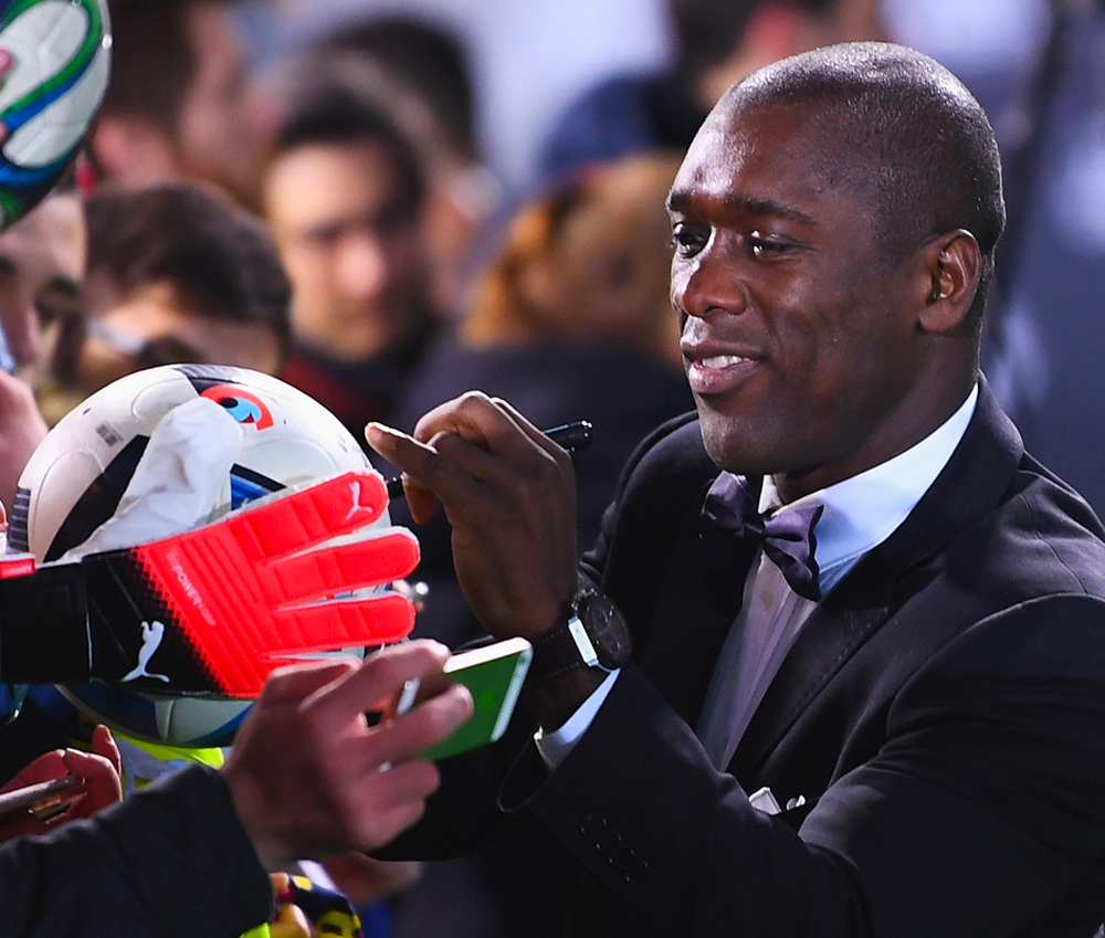 Clarence Seedorf signing a soccer ball